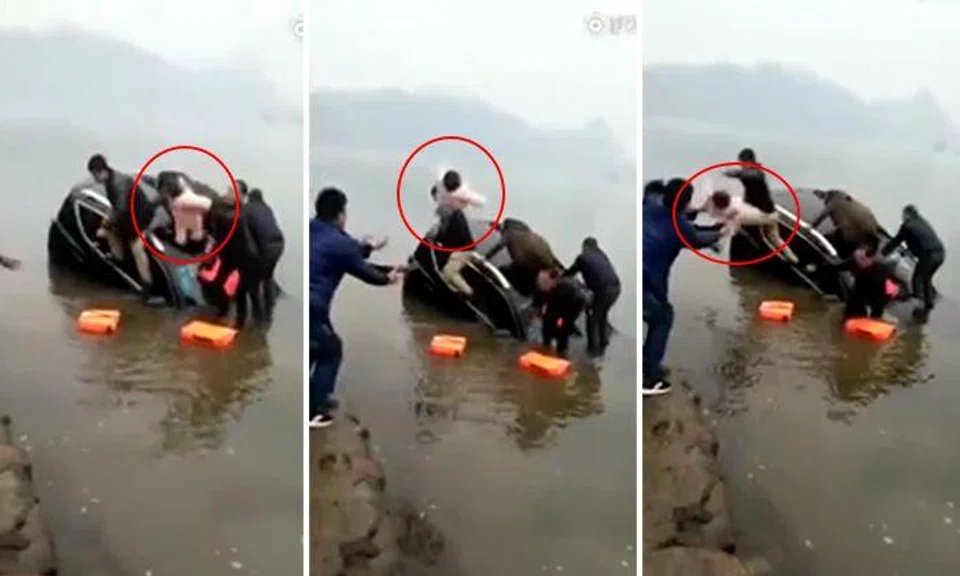 Desperate dad on sinking car throws infant daughter to onshore onlookers in China