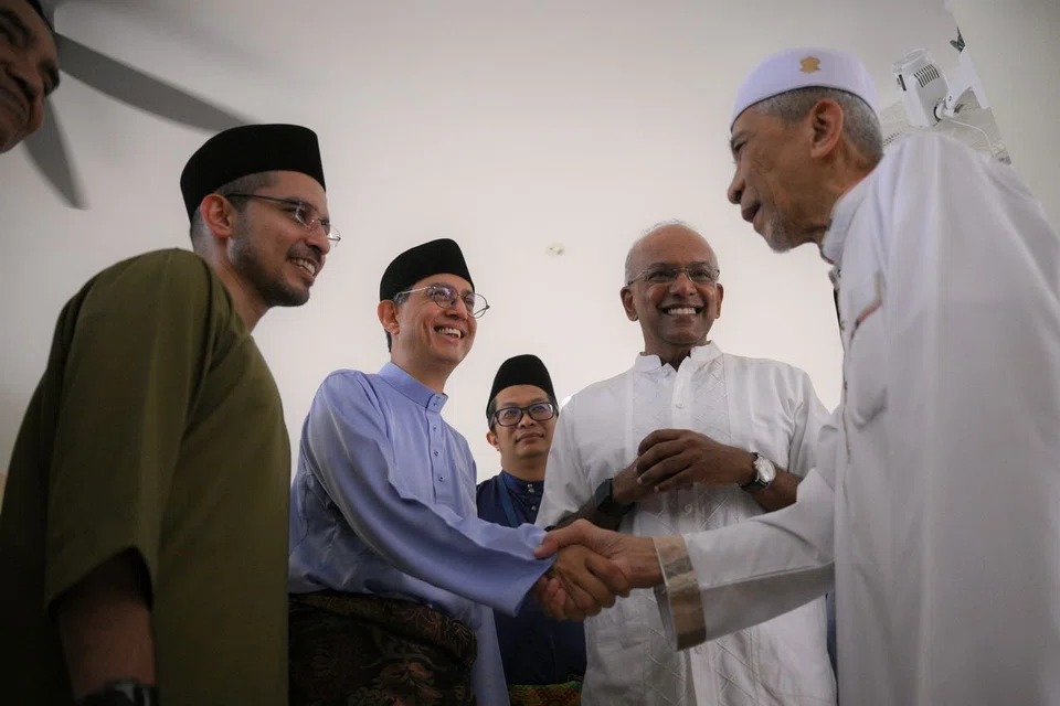 (From left) Nee Soon GRC MP Syed Harun Alhabsyi; Acting Minister-in-charge of Muslim Affairs Faishal Ibrahim; executive chairman of Masjid Darul Makmur Mohd Fairus Abdul Manaf; and Minister for Home Affairs K. Shanmugam greet a congregant after Hari Raya Aidiladha prayers.