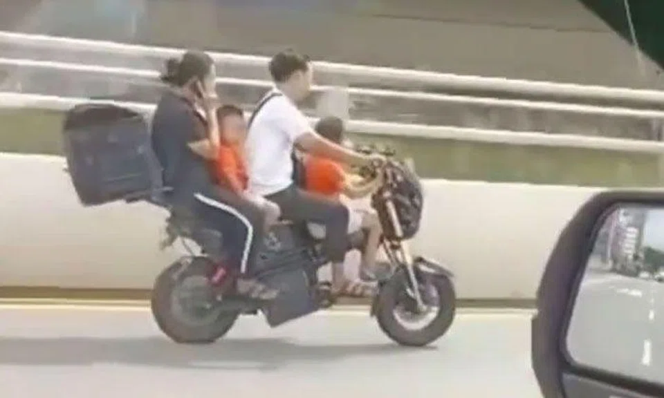Family of four squeeze onto e-bike and ride along Kallang Road without helmets at up to 60 kmh
