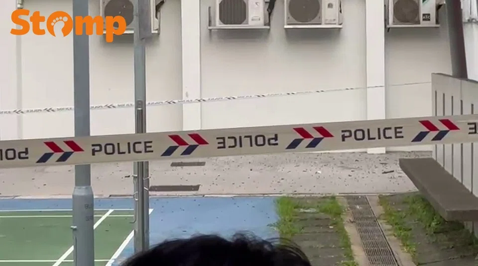 Debris was observed falling onto the ground at the foot of the block.