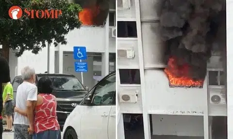 The videos show flames and thick black smoke coming out of the flat window. People gathered to watch and at least three SCDF vehicles were at the scene.
