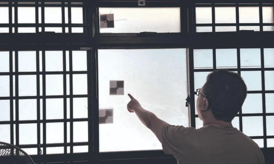 windows hit by marbles hougang