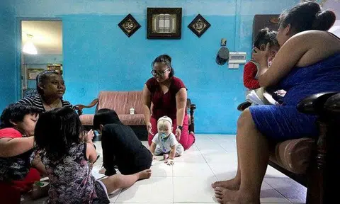 Miss Nurul Asyiqin Buang (centre) and her family in their two-room rental flat. TNP PHOTO: PHYLLICIA WANG