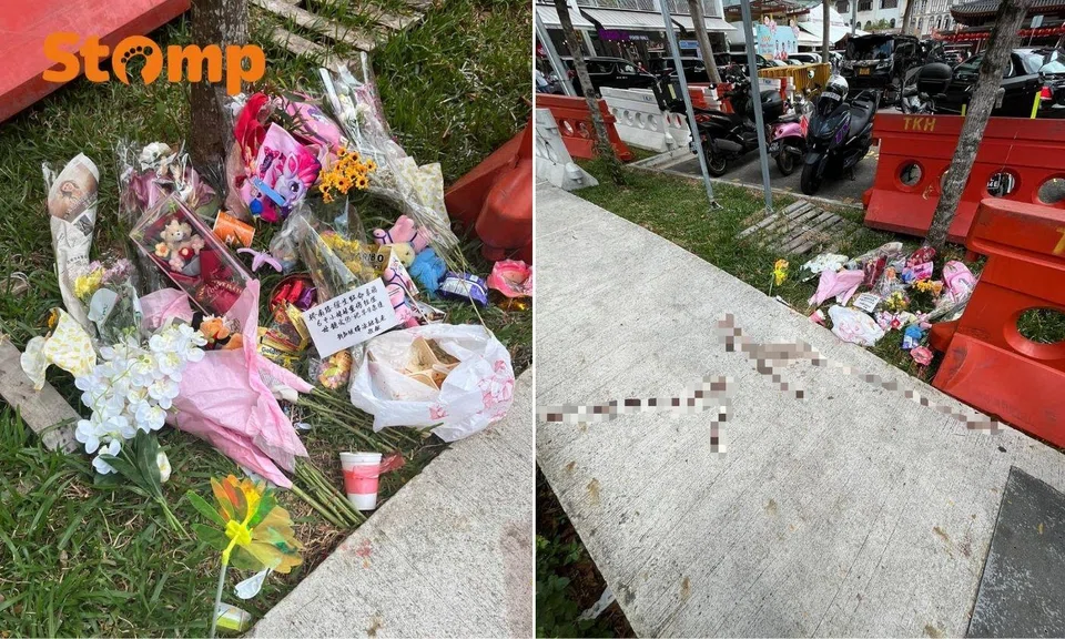 Tribute left at the entrance of the carpark included flowers, bento meals, and plush toys. 