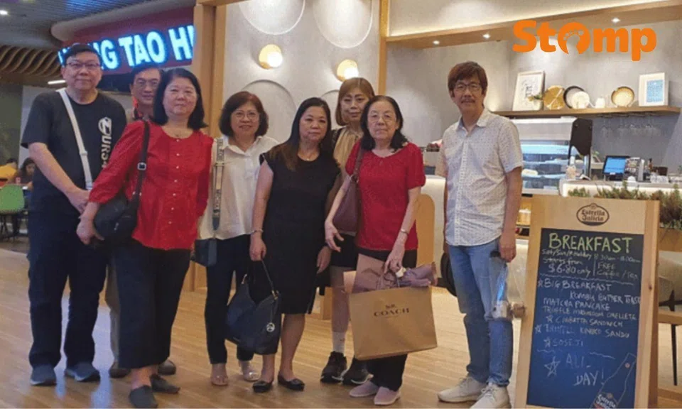 Eight people from the now-defunct Guillemard Road English School at a reunion dinner.