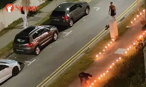 Burning candles next to electrical box along walkway in Geylang: Is this a fire safety issue?