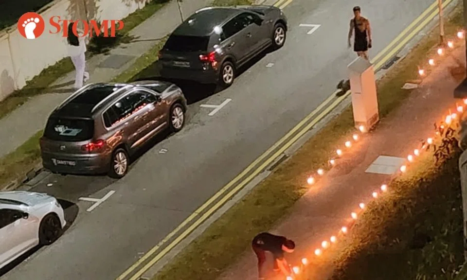 The Stomper shared photos of lit candles lining both sides of a public path.