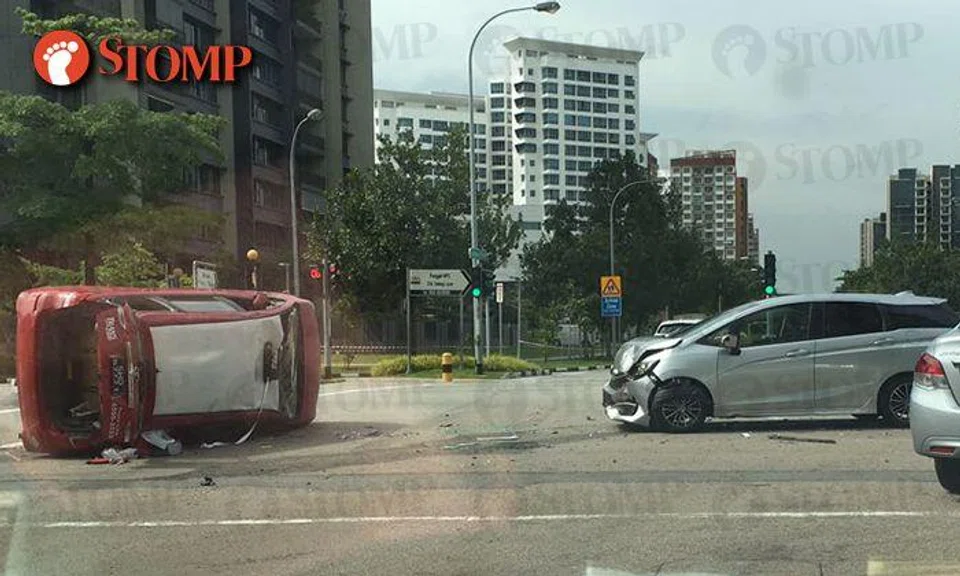 Trans-cab taxi overturns after colliding with silver wagon at junction between Edgefield Plains and Punggol Fields