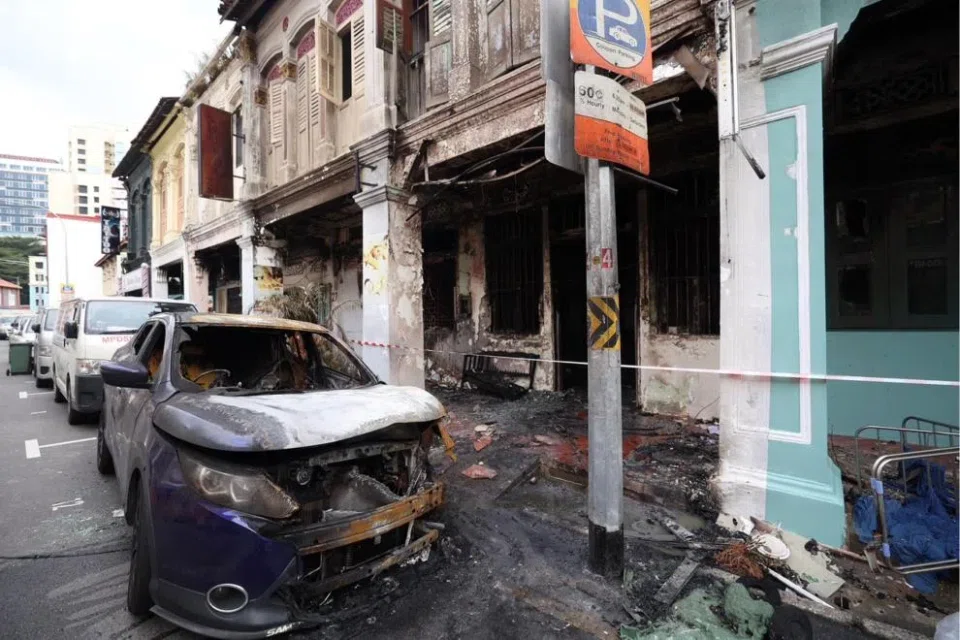 A blue car parked in front of the shophouse was also affected by the fire.