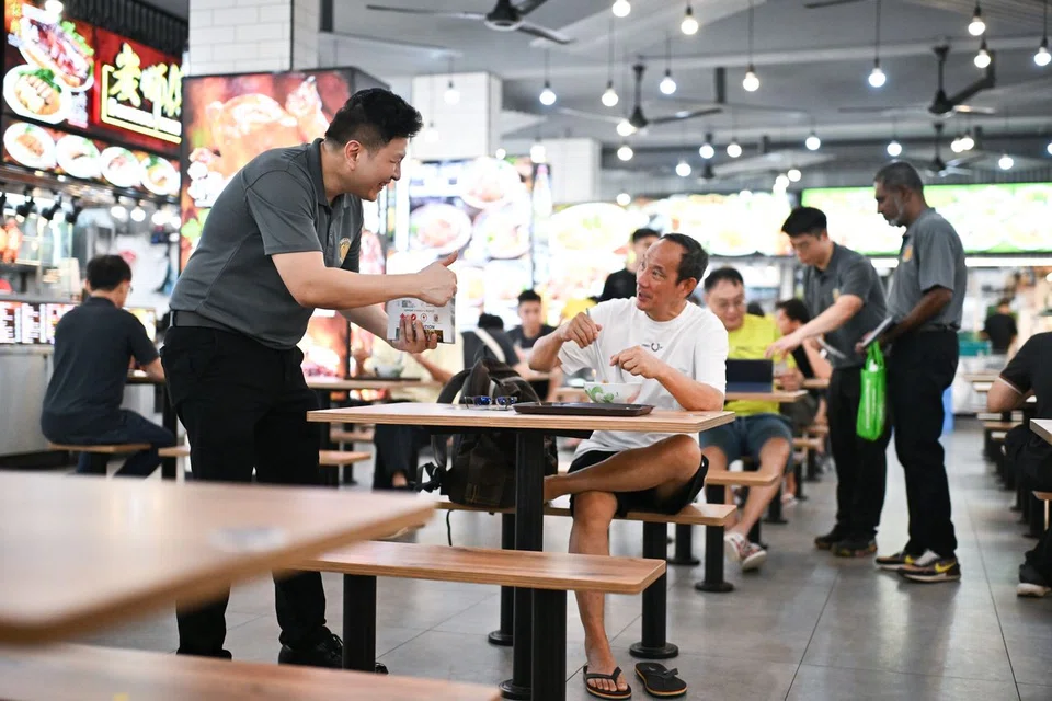 SUP secretary-general Andy Zhu (far left) interacting with residents during walkabout at a coffeeshop on April 10.