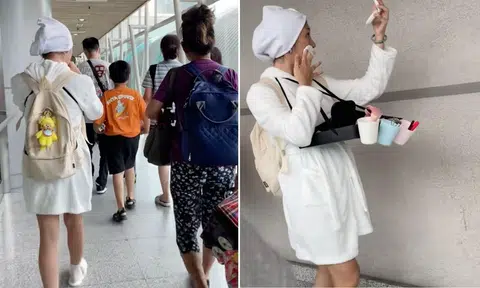 Woman strolls to JB checkpoint in bathrobe and slippers while doing makeup: 'Queen'