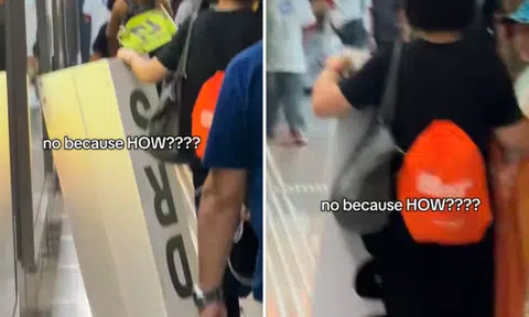 woman lugs DRS sign from Singapore Grand Prix track