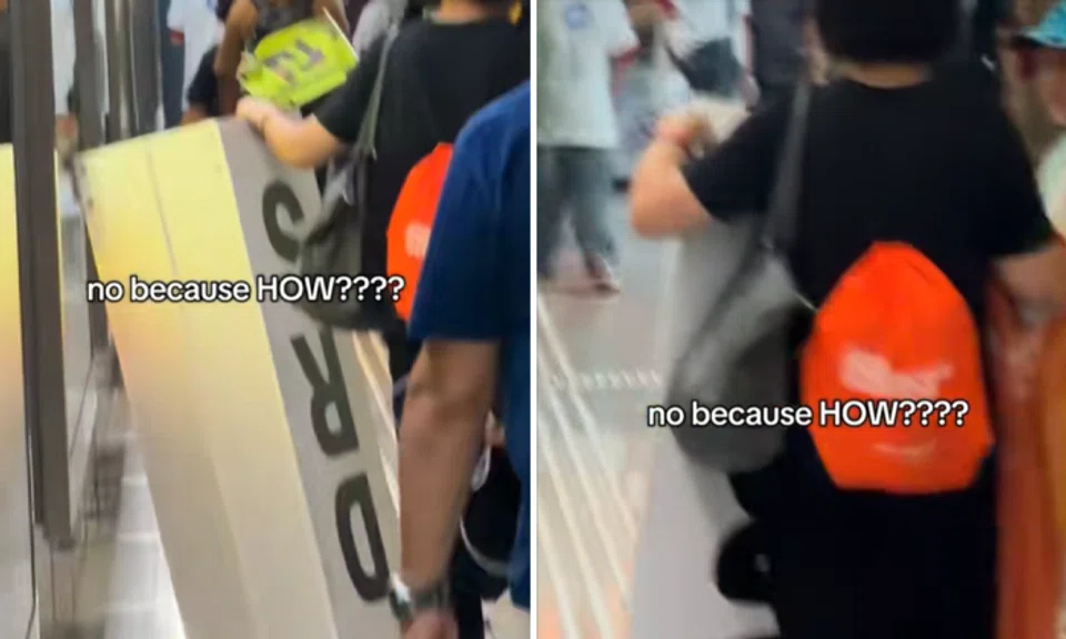 woman lugs DRS sign from Singapore Grand Prix track
