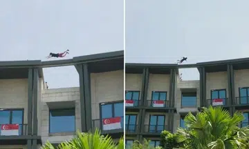 man jumping across rooftop gap at rws hotel