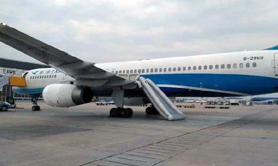 Evacuation slide deployed on flight from Beijing after woman opens emergency door