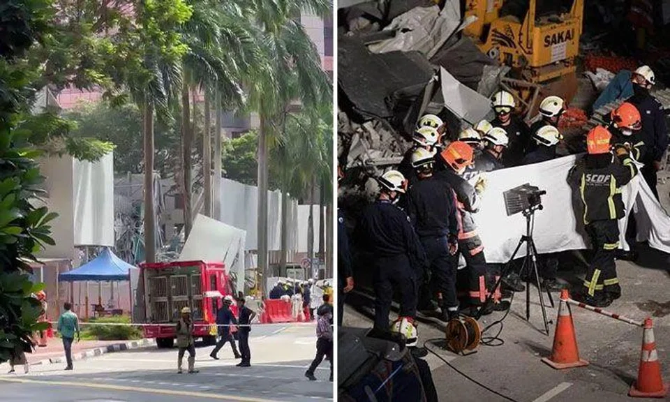 The body (right) being pulled out and brought to be examined at around 9.45pm, on June 15, 2023. ST PHOTO: SHINTARO TAY