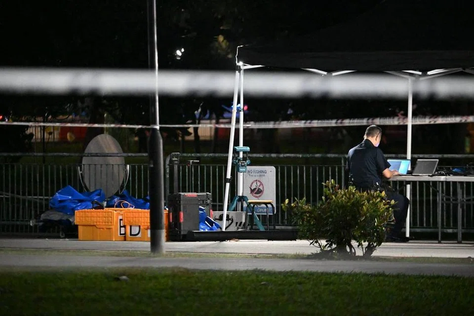 A police officer at Siglap Canal next to a carpark at East Coast Park on the night of Aug 30. ST PHOTO: LIM YAOHUI