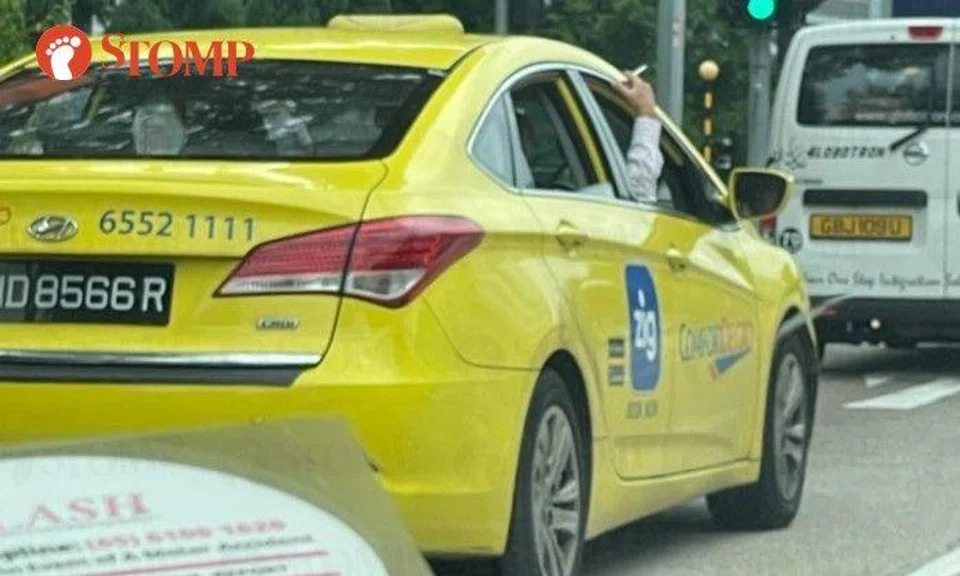 Stomper Edros shared photos of a cabby in a yellow ComfortDelGro taxi holding a cigarette outside the vehicle window.