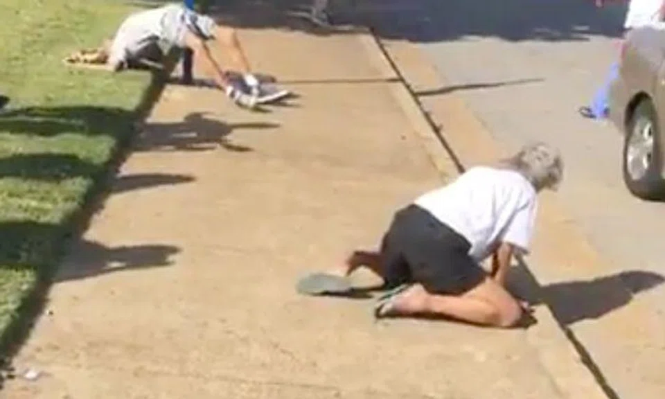 Shocking clip shows American couple overdosing on drugs in broad daylight, as passers-by mock and film them