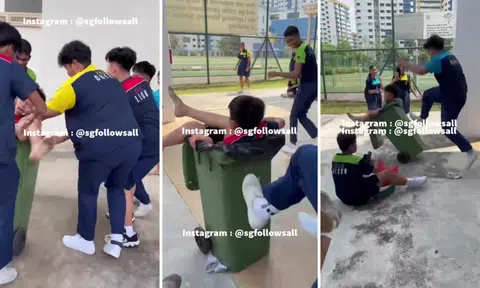 Boy ends up in trash bin that schoolmates kick until it rolls away and topples over as they laugh