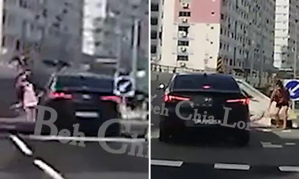 Debate over who's at fault after woman jumps out of the way to avoid car, but her bag gets hit