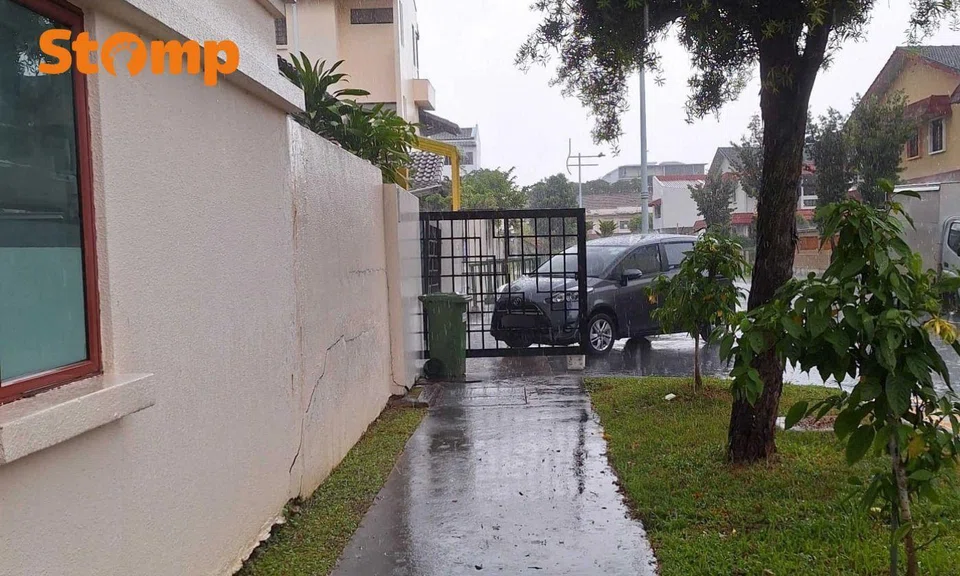 Preschool gate left open, car blocking public walkway in the rain