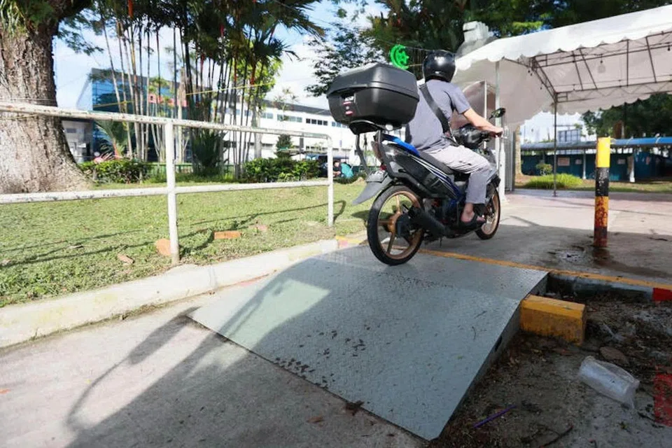 A metal ramp was set up to help motorcyclists reach the makeshift parking spot behind the food centre.