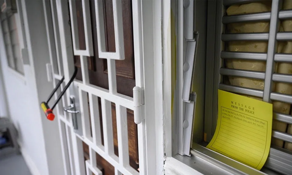 A note placed by the police instructing people not to remove the lock outside the unit at Block 125 Ang Mo Kio Avenue 6, where a 66-year-old man was arrested for suspected murder, on Nov 29. ST PHOTO: MARK CHEONG