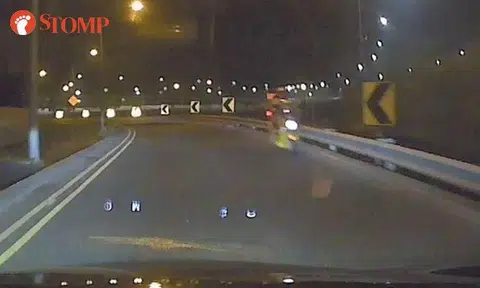 Motorcyclist riding against traffic along TPE