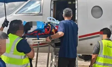 man in coma being medically evacuated