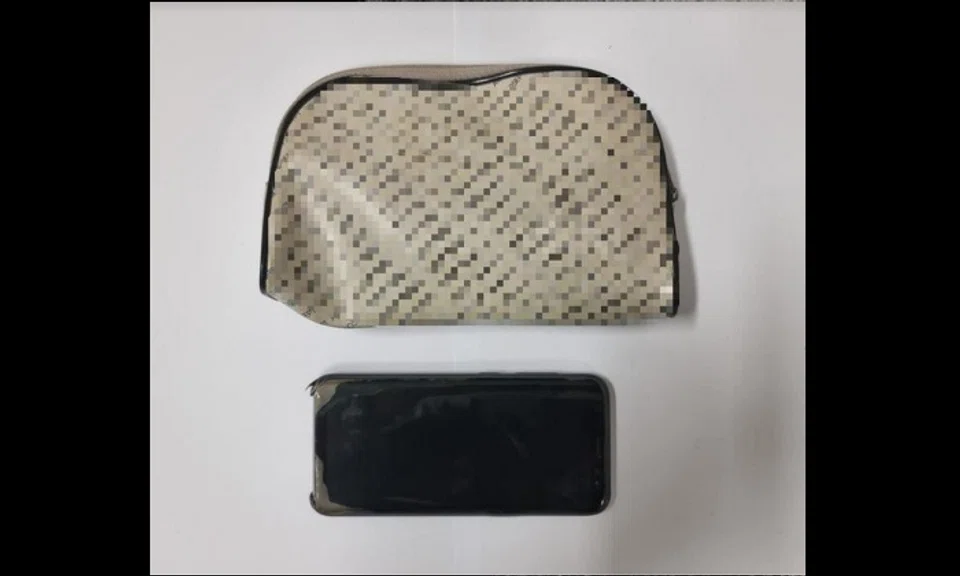 The clutch bag and mobile phone were recovered and seized as case exhibits.