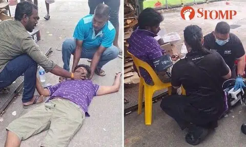 The man was lying on the ground as one of his colleagues supported his head and another held his jaw.
