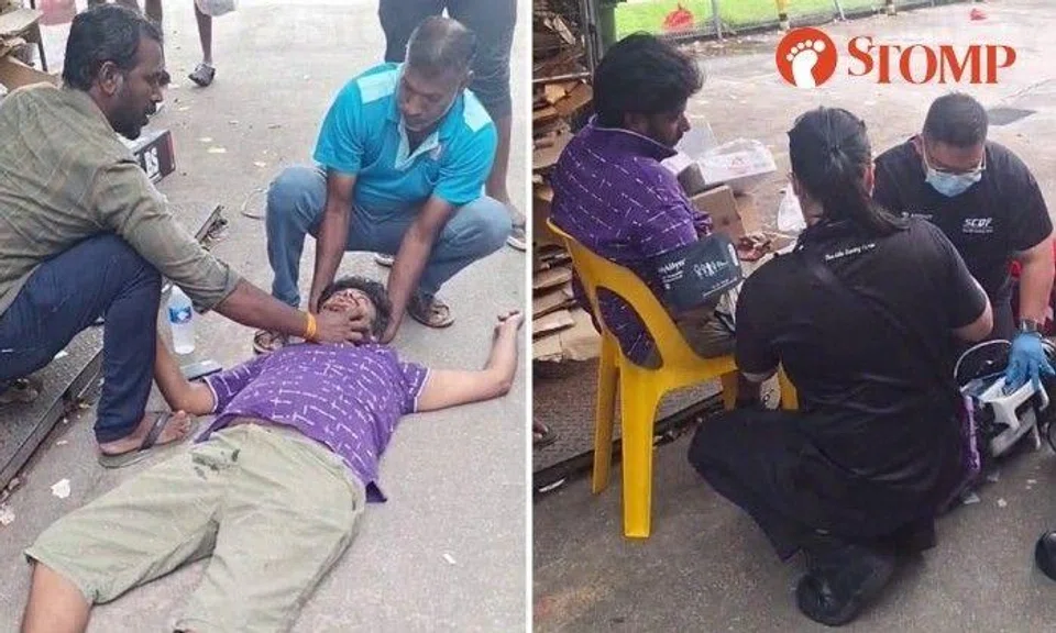 The man was lying on the ground as one of his colleagues supported his head and another held his jaw.