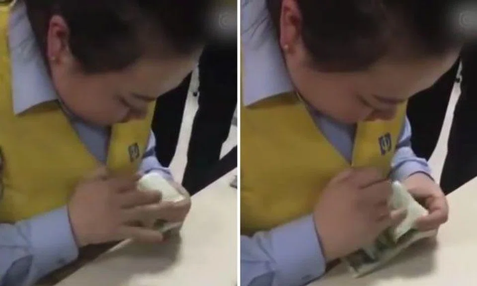 Look at those fingers go! Chinese woman counts money faster than cash-counting machine