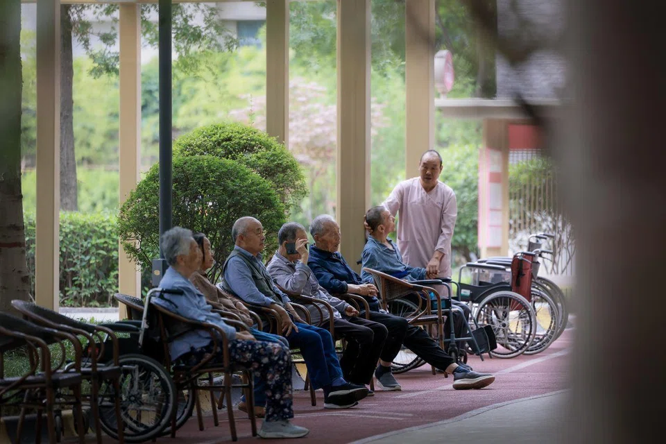 Elderly residents sitting outside their accommodation block at the Perennial Alzheimer’s Care Village in Xi’an on June 4.