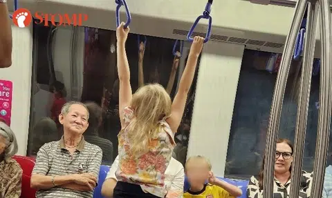 Parents encourage child to hang on MRT handrail, mum shouts at Stomper for taking photo
