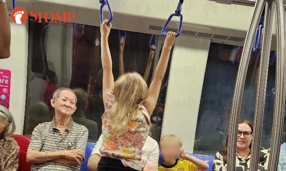A child was caught on camera hanging on the handrail of the train at the encouragement of the parents, according to Stomper Ethan.