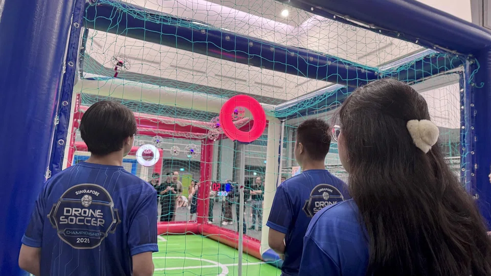 Strikers Zhu Zixuan and Claudia Lee (right) stand in front of the “cage”, where a match takes place.