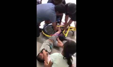 Boy cries in pain while passers-by try to free his leg trapped in bicycle frame