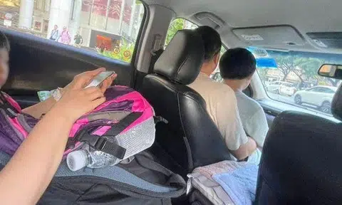 Woman books GrabShare ride but family of 4 shows up, man ends up sitting with boy in front seat
