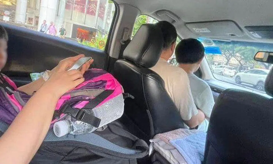 Woman books GrabShare ride but family of 4 shows up, man ends up sitting with boy in front seat
