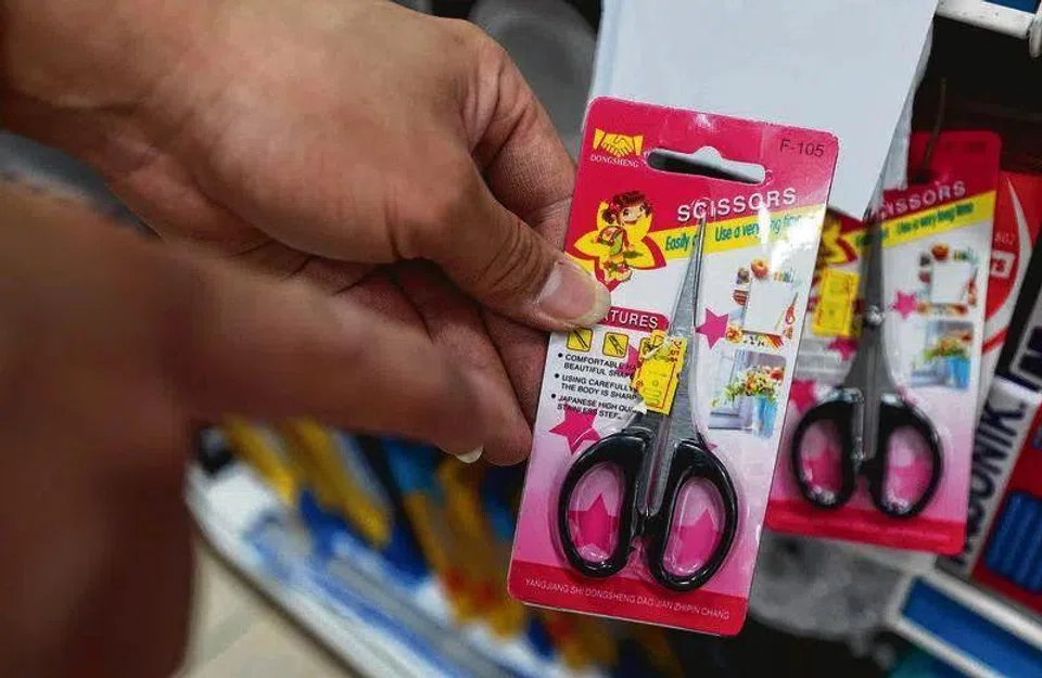 Scissors used by the man to create a scene.