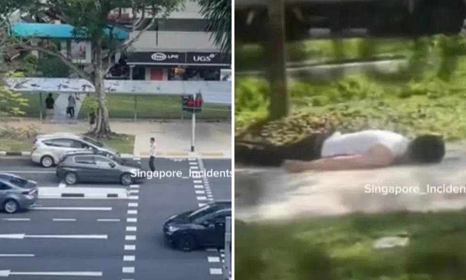 The man blocked cars from moving on the road while the pedestrian light was red.