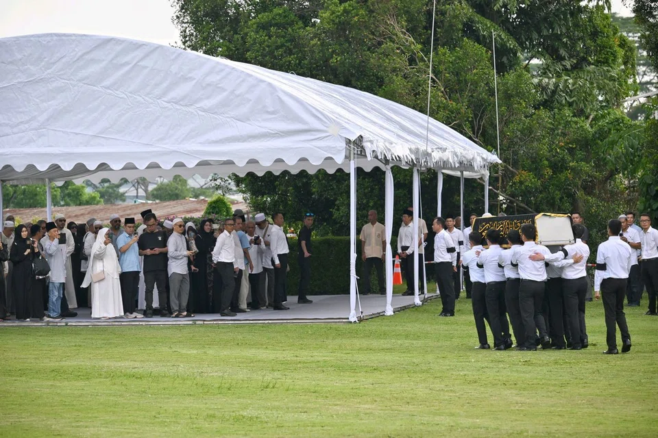 The casket of Puan Noor Aishah being carried by pallbearers at Kranji State Cemetery on April 22.