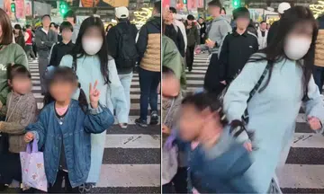 Woman slammed for shoving girl posing at crowded Shibuya Crossing in Tokyo