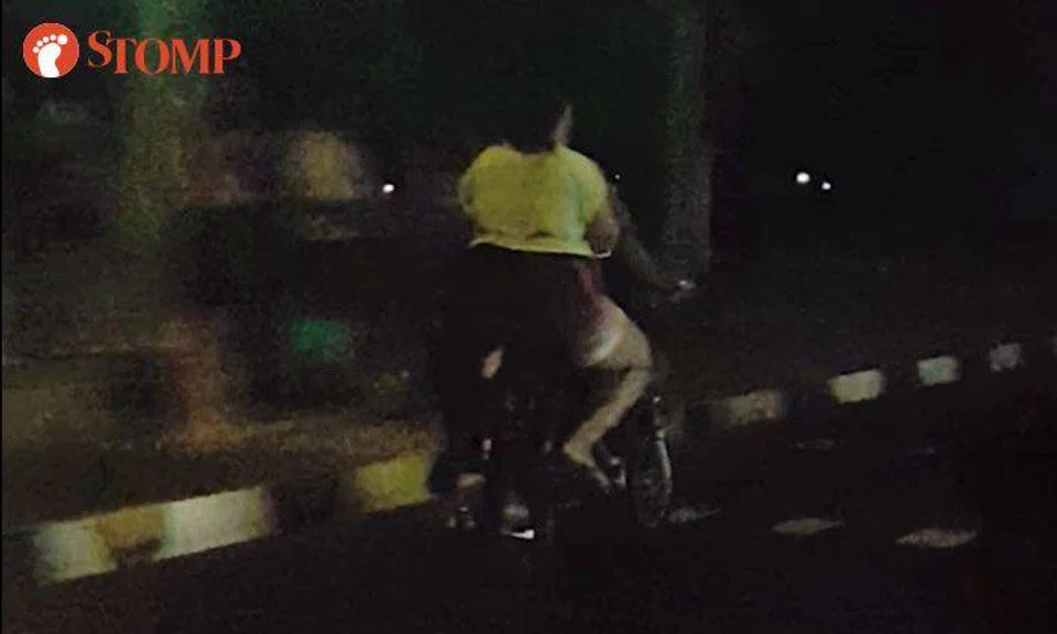 E-biker zooms down Holland Road with pillion rider -- and neither of them are wearing helmets