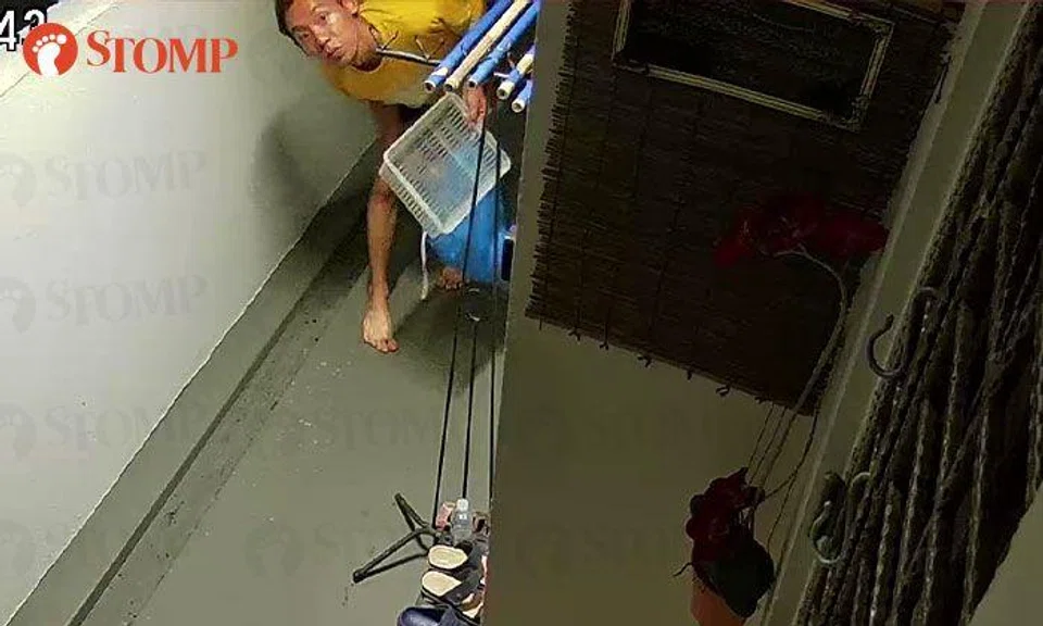 Man holding basket creeps outside Bukit Batok flat, then flees after spotting CCTV camera