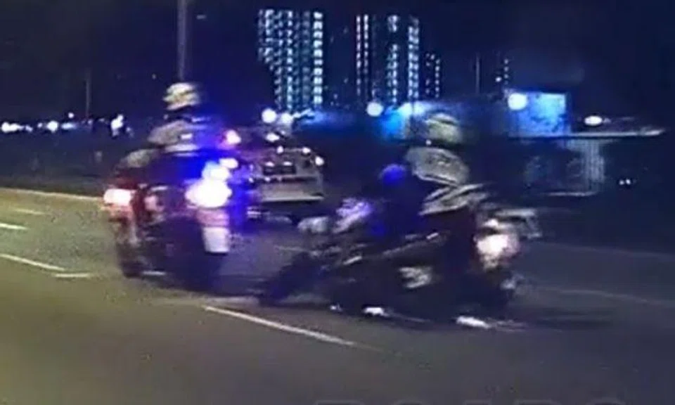 TP officer skids after coming into contact with glass shards on road. (PHOTO: ROADS.SG)