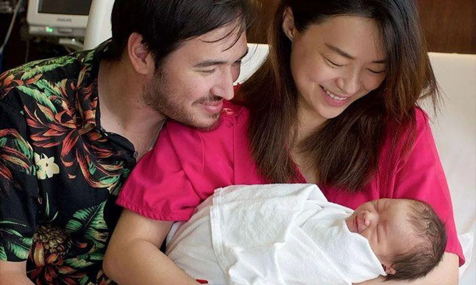 Rebecca Lim shared a family photo of her cuddling her newborn son with husband Matthew Webster looking on. PHOTO: REBECCA LIM/INSTAGRAM