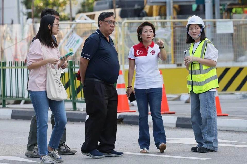 MP for Mountbatten SMC Gho Sze Kee (second from right) interacting with LTA and PUB staffs at the site of the sinkhole along Tanjong Katong South road at 8.56am on July 27.